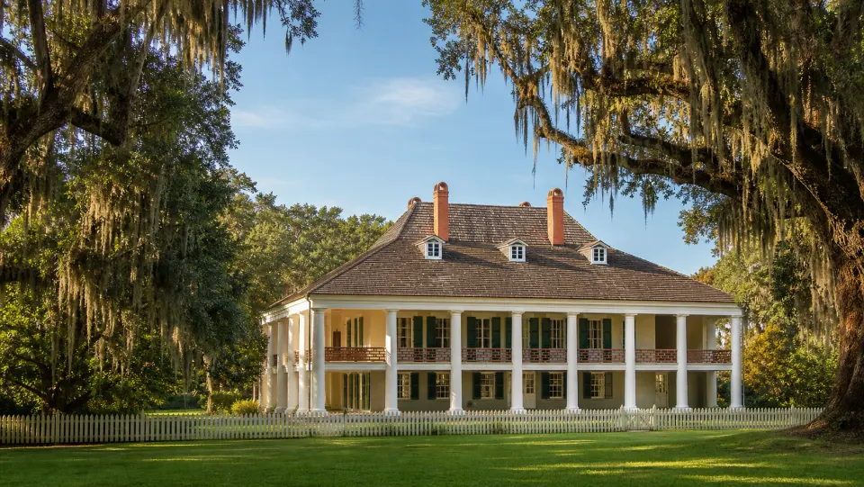 The main house at Destrehan Plantation, framed by live oaks draped in Spanish moss